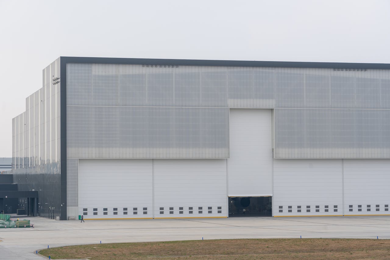 Front view of a large modern warehouse with closed doors, showcasing industrial architecture